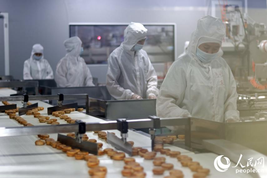 生產(chǎn)線上,工人們正在進(jìn)行品控。人民網(wǎng) 李昌乾攝